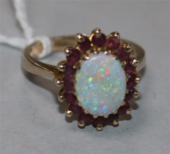 A 9ct gold, ruby and white opal cluster ring, size O.